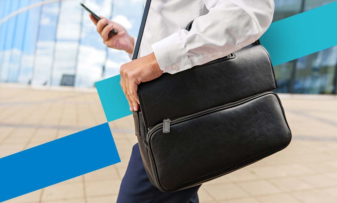 Man with briefcase and cell phone - Contact page for dealers and distributors of Schildknecht AG